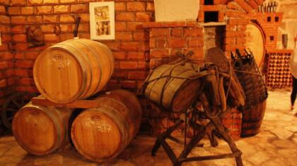 Wine barrels and old equipment in a wine cellar